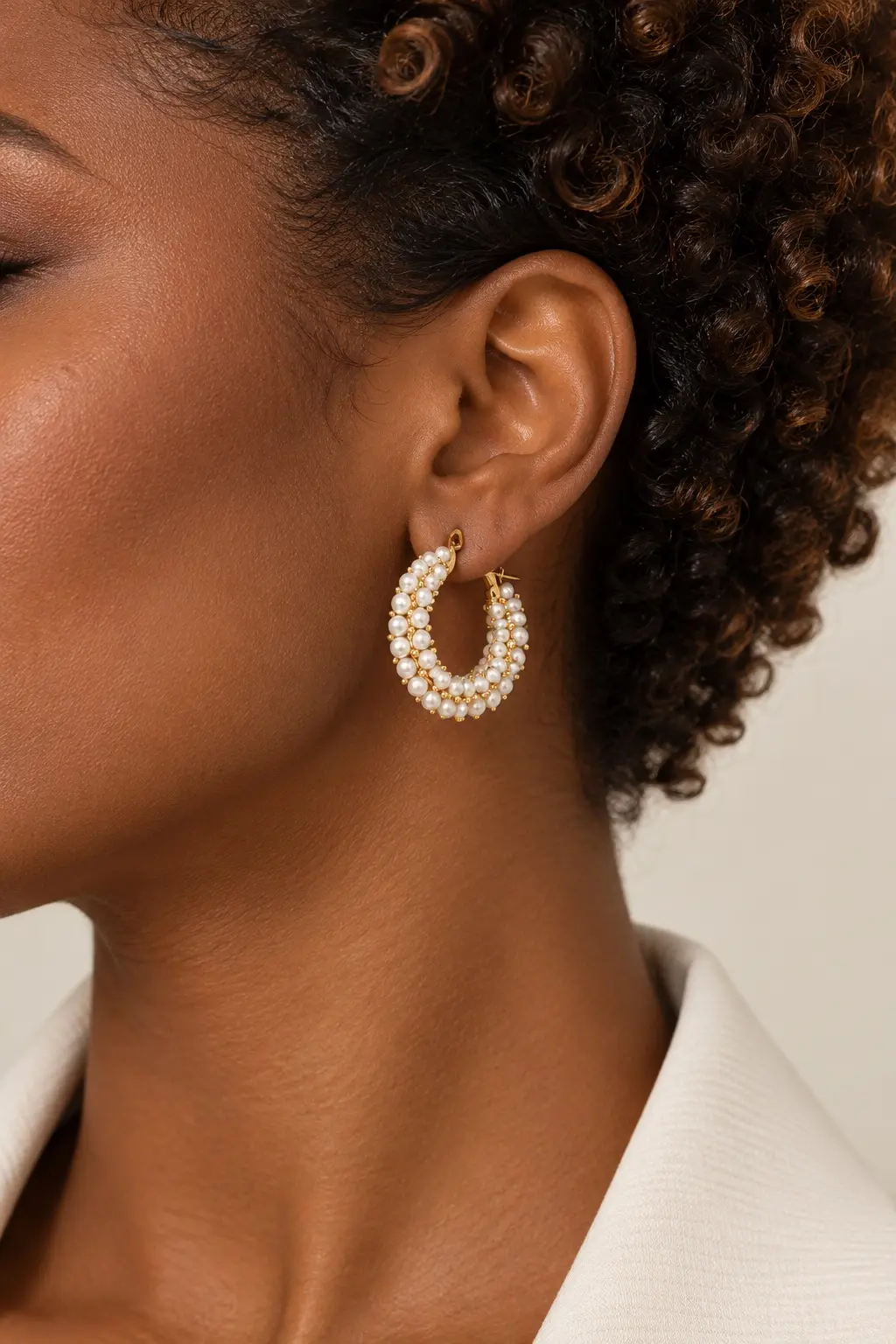 Vellora pearl hoop earring worn on the ear